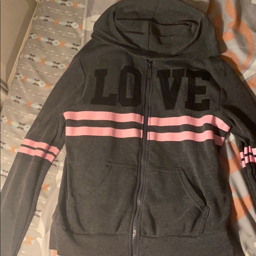 A grey and pink hoodie with the letters LOVE on it